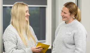 Kurrajong staff smiling and chatting in the office